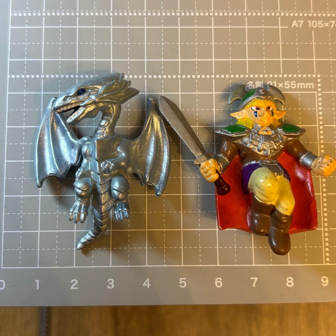 Vintage Yu-Gi-Oh! Duel Swing Blue-Eyes White Dragon and Elf Swordsman figures; metal fittings are missing.