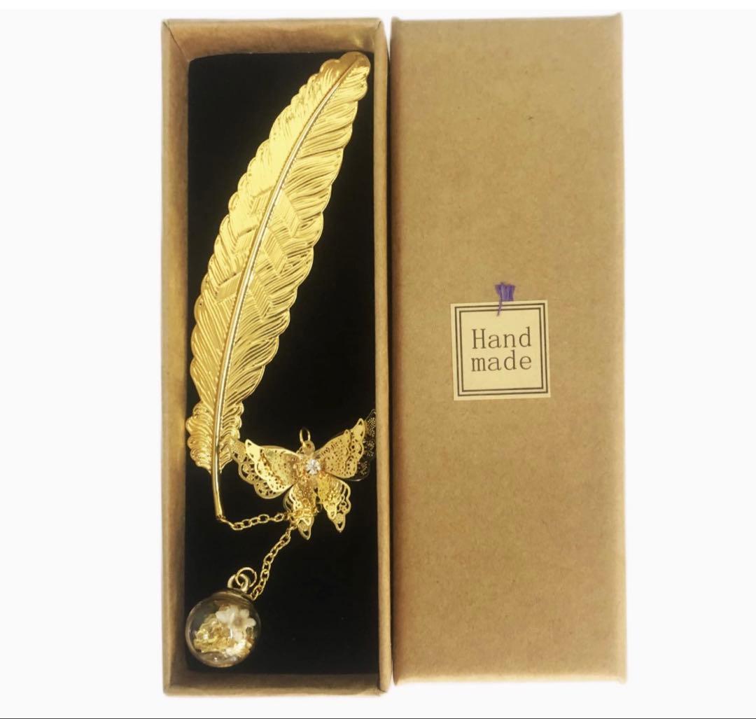 Gold-colored bookmark with feather motif