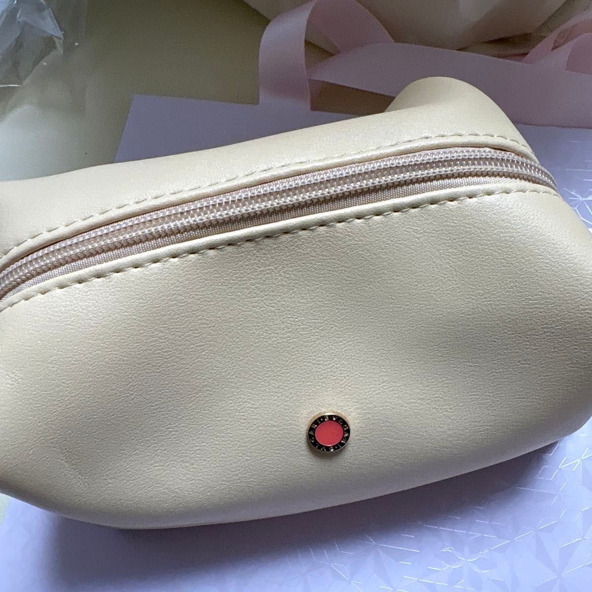 New, unopened BVLGARI Emirates Airlines Business Class amenity pouch, beige with orange logo