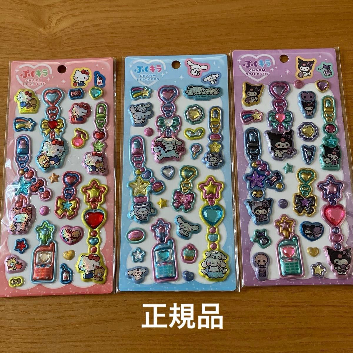 New, unopened, genuine Sanrio Puku-Kira charm stickers—Hello Kitty, Cinnamoroll, and Kuromi.