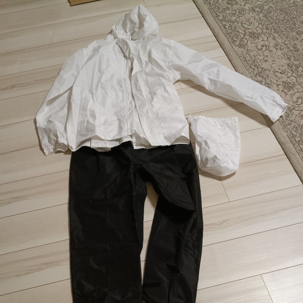 Rainwear set (top and bottom), with hood, includes storage bag, available in white and black, size S, purchased from Workman.