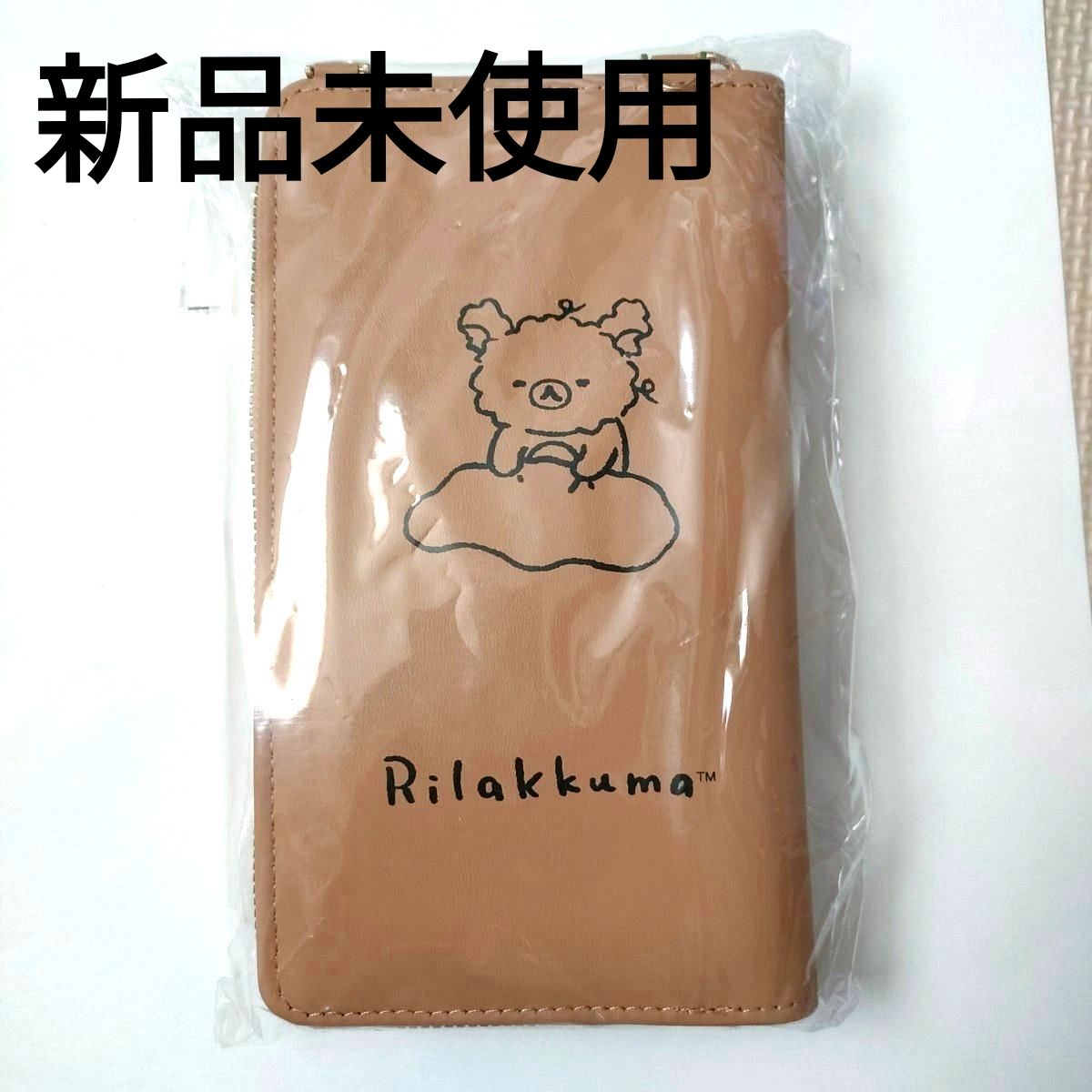 New, unused Rilakkuma wallet, smartphone case, and shoulder bag in brown.