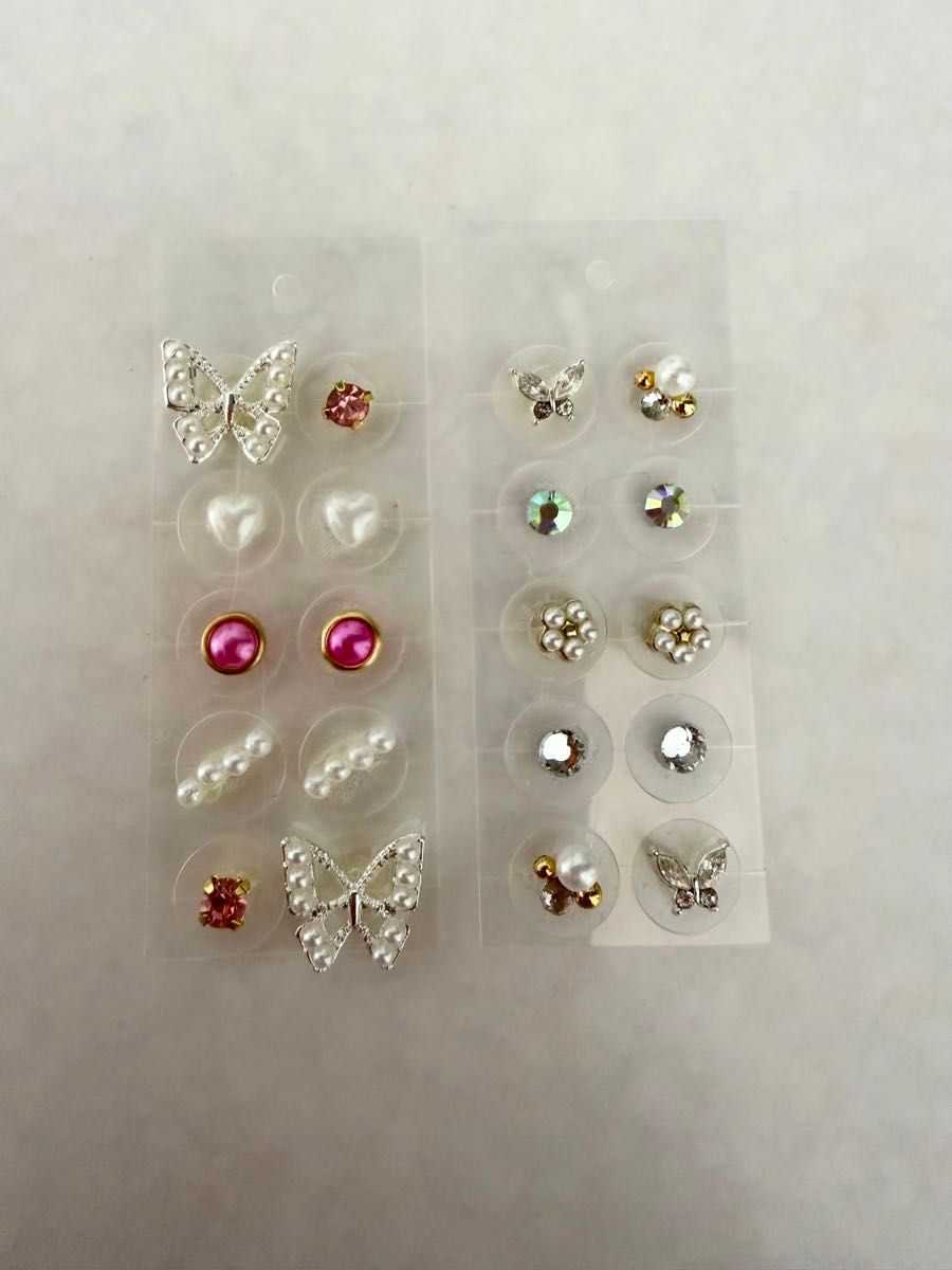 Ear acupressure jewelry, 20 pieces—pearls, butterflies, pink, and floral designs.