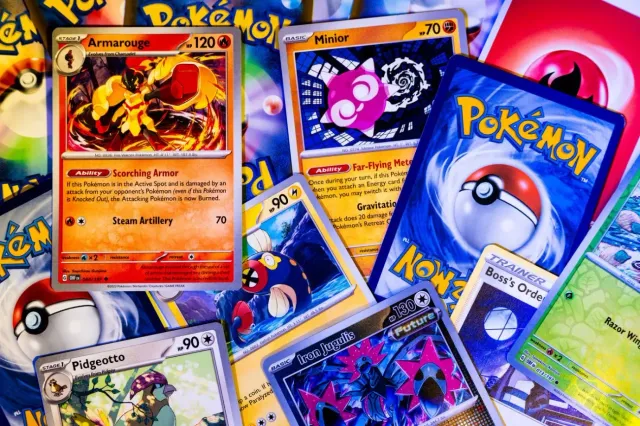 Japanese Pokémon card binder pages and sealed Pokémon booster boxes displayed in a collector shop