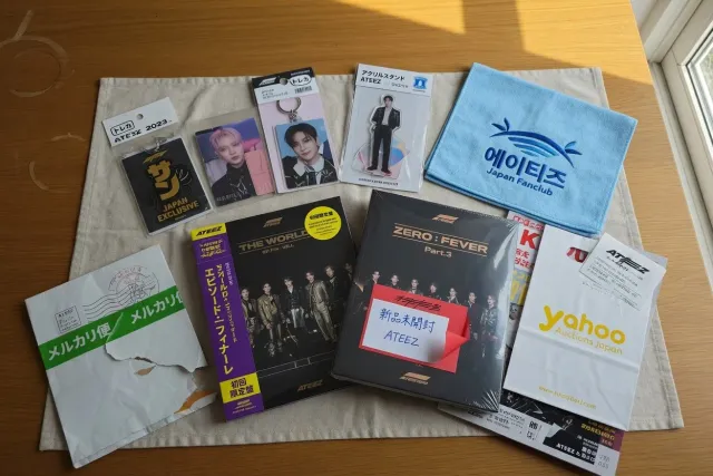 ATEEZ merch from Japan including Japanese albums, photocards, and concert goods laid out for collectors