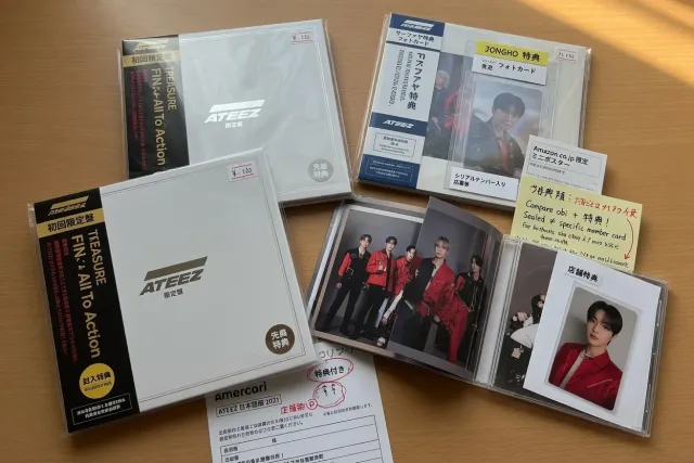ATEEZ Japanese edition albums with obi strips, sealed packaging, and store-exclusive photo benefits arranged on a table