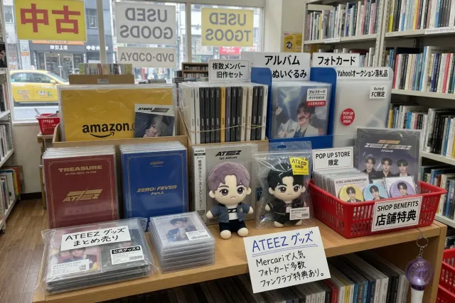 ATEEZ albums, character plush dolls, and Japanese store benefits displayed in a Tokyo resale shop