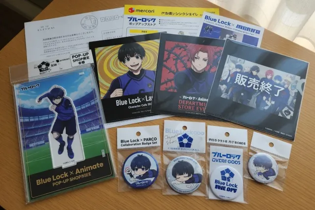 Official Blue Lock collaboration merchandise with event acrylic stands, badges, and clear files from Japan
