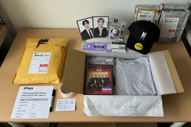 Packed BTS merchandise from Japan including albums, photocards, and accessories prepared for international shipping