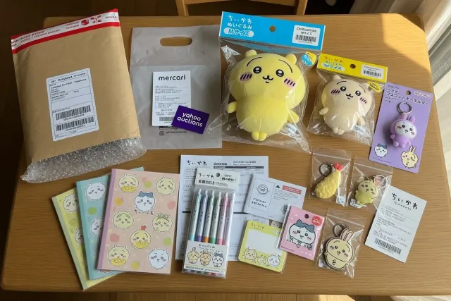 Assorted Chiikawa characters merchandise including plush toys, keychains, and stationery from Japanese stores