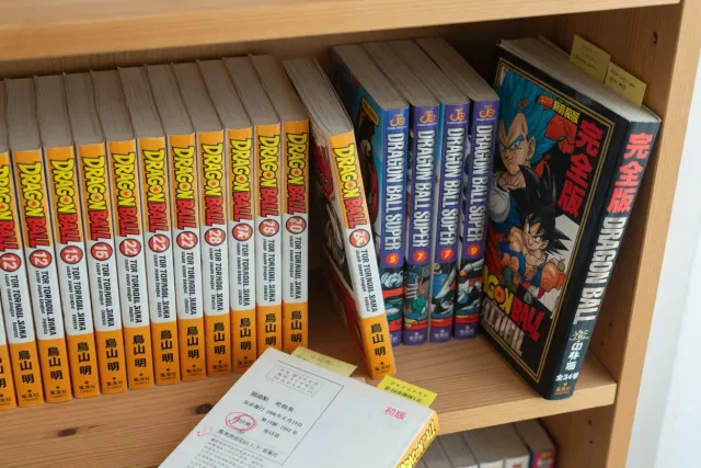 Japanese Dragon Ball manga volumes with colorful spines and Dragon Ball Super Manga books on a shelf