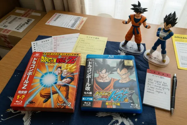 Dragon Ball Z and Dragon Ball Z Kai Japanese Blu-ray cases displayed beside Goku and Vegeta figures