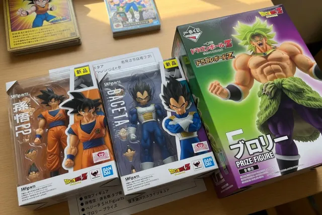 Dragon Ball Z action figures of Goku, Vegeta, and Broly in original Japanese boxes