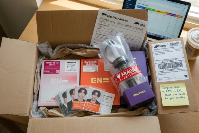 Packed ENHYPEN official merchandise ready for international shipping, with albums, photocards, and a lightstick protected in a parcel
