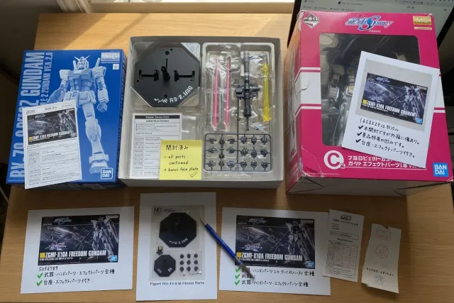 Authentic-looking Gundam Japanese collectibles with product boxes, accessories, figure bases, and seller photographs