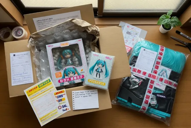 Packed Hatsune Miku figures and cosplay accessories prepared for international shipping from Japan