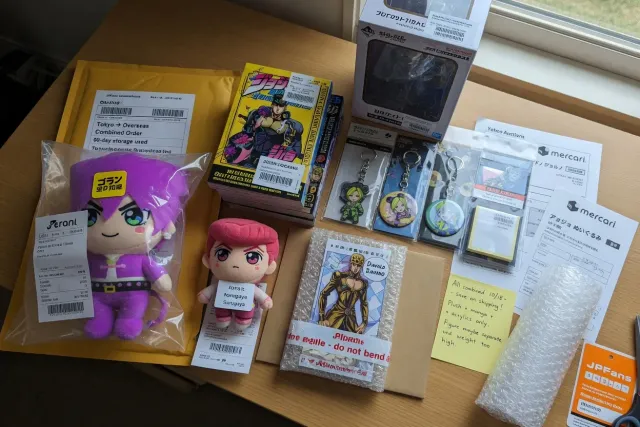 Several JoJo's Bizarre Adventure orders including plush toys, acrylic stands, and manga grouped together for international shipping