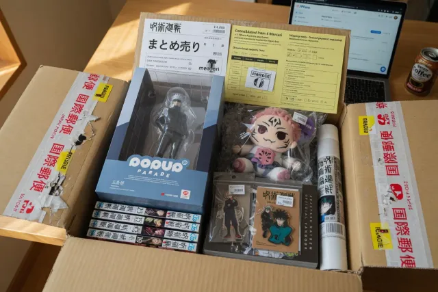 A consolidated Jujutsu Kaisen merchandise parcel from Japan with manga, figures, and collector goods