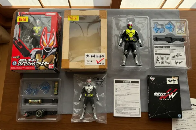 New and pre-owned Kamen Rider figures displayed with sealed boxes and open accessory trays