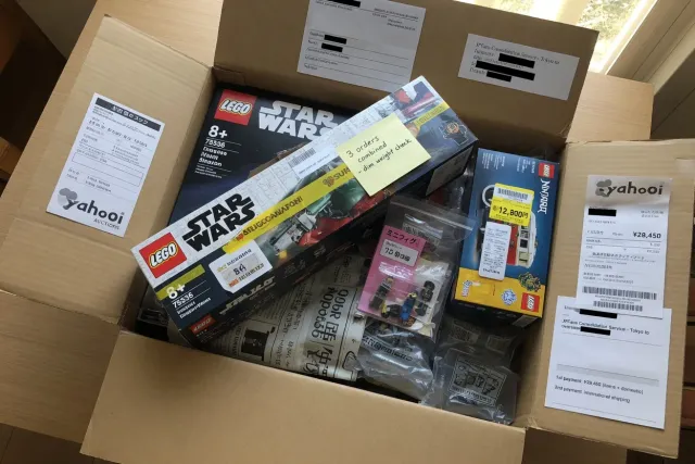 Several LEGO orders packed together in one shipping carton, showing package consolidation for LEGO from Japan