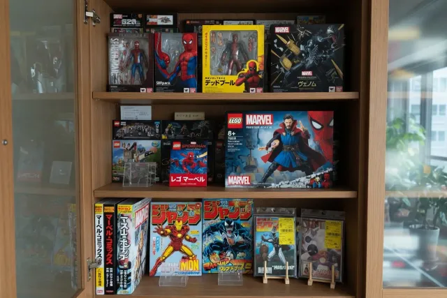 Japanese Marvel figures, LEGO sets and comics displayed in a collector's cabinet