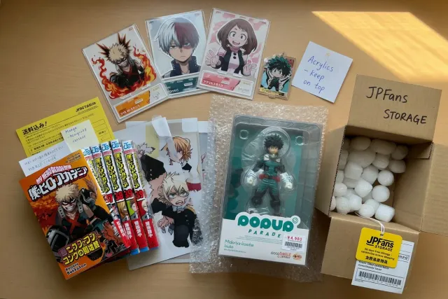 Several My Hero Academia manga, figures, and acrylic stands packed together for international consolidation