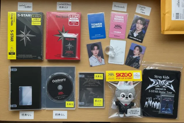Stray Kids album editions, official photocards, SKZOO plush, and Japanese concert merchandise arranged for comparison