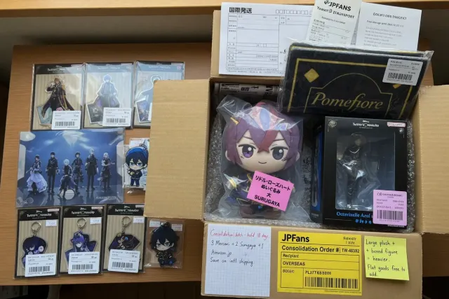 Packed Twisted Wonderland merchandise from Japan including acrylic stands, plush goods, and boxed figures ready for international shipping