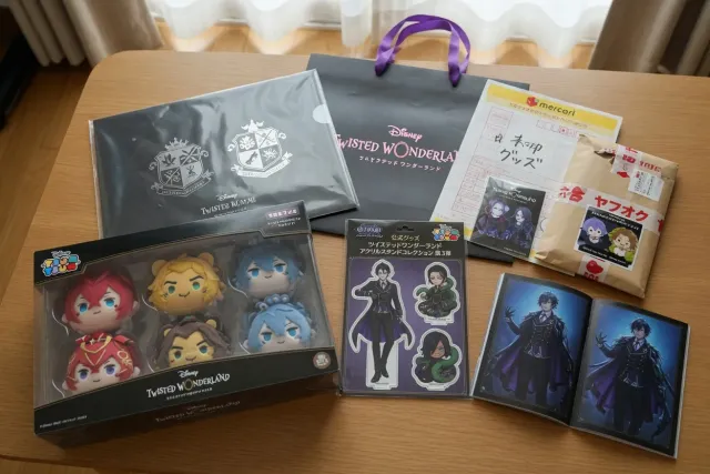 Twisted Wonderland merchandise from Japan, including character acrylic stands, plush toys, and trading goods